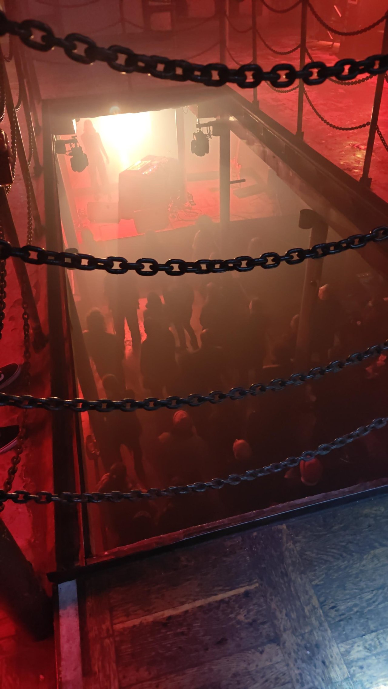 View down the opening into the cargo hold. Opening is secured with metal chains.